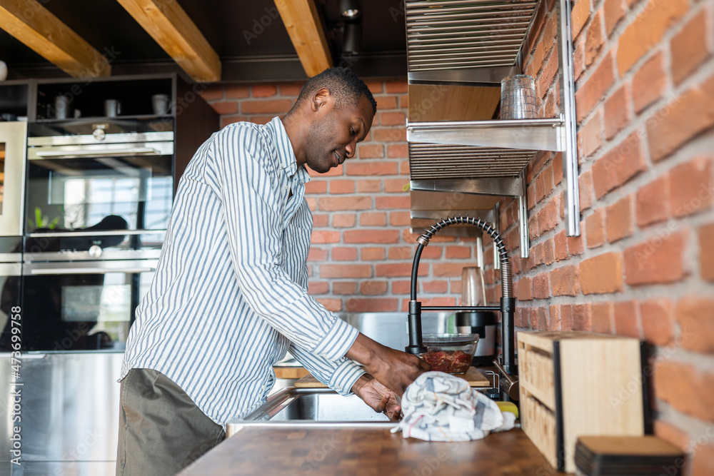 Man Cleaning At Kitchen Man Cleaning At Kitchen