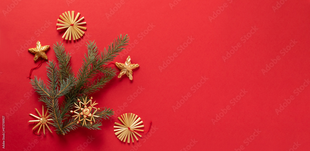 Fluffy branches of fir-tree Christmas toys made from natural materials of straw, red background. concept Christmas New Year. Fluffy branches of fir-tree Christmas toys made from natural materials of straw, red background. concept Christmas New Year.