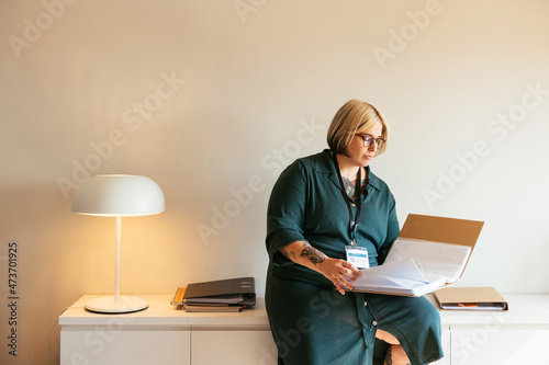 Woman reading documents in folder photo