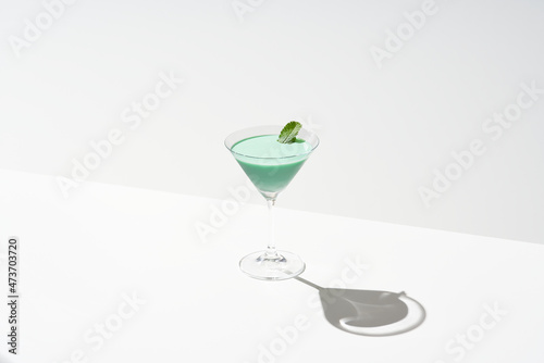 Glass of green grasshopper cocktail photo