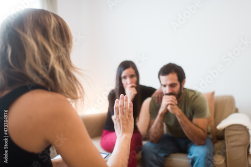 Worried couple listening to their therapist photo