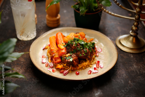 Lamb stew with groats and carrots. Jewish kosher dish. Culinary photography. Suggestion to serve the dish.