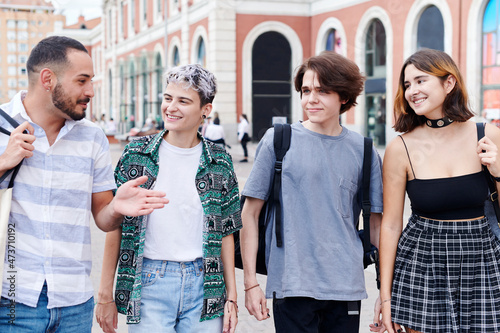 Smiling young lgbt friends walking together photo