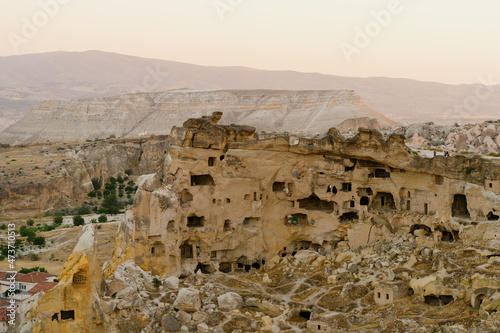 Cappadocia, Turkey - 21 July 2021. Day view of Goreme town with blue clear sky on horison. Famous center of balloon fligths photo