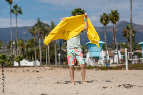 Boy drying off with beach towel