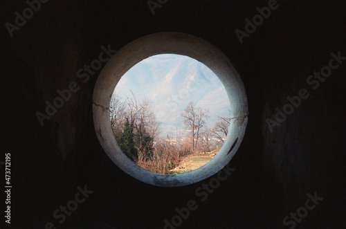 A beautiful round window in the Italian mountains  photo