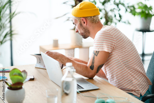 Male designer reading magazine