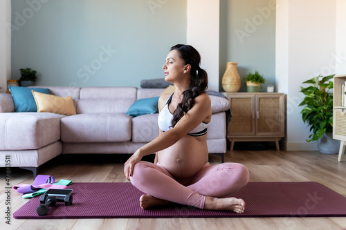 Pregnant Woman Sitting On The Floor And Stretching