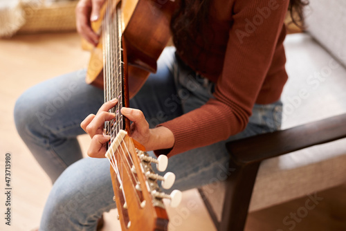 Skilled woman playing guitar