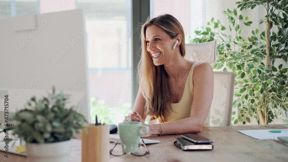 Video of freelance woman gesturing while discussing during video conference at home.