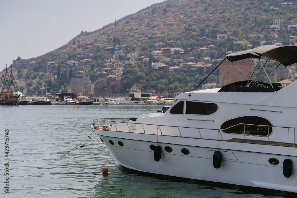 Fototapeta premium Alanya, Turkey - 24 July 2021: Sea pier port for yachts and boats in marina on a background of mountainous terrain. Sea coast