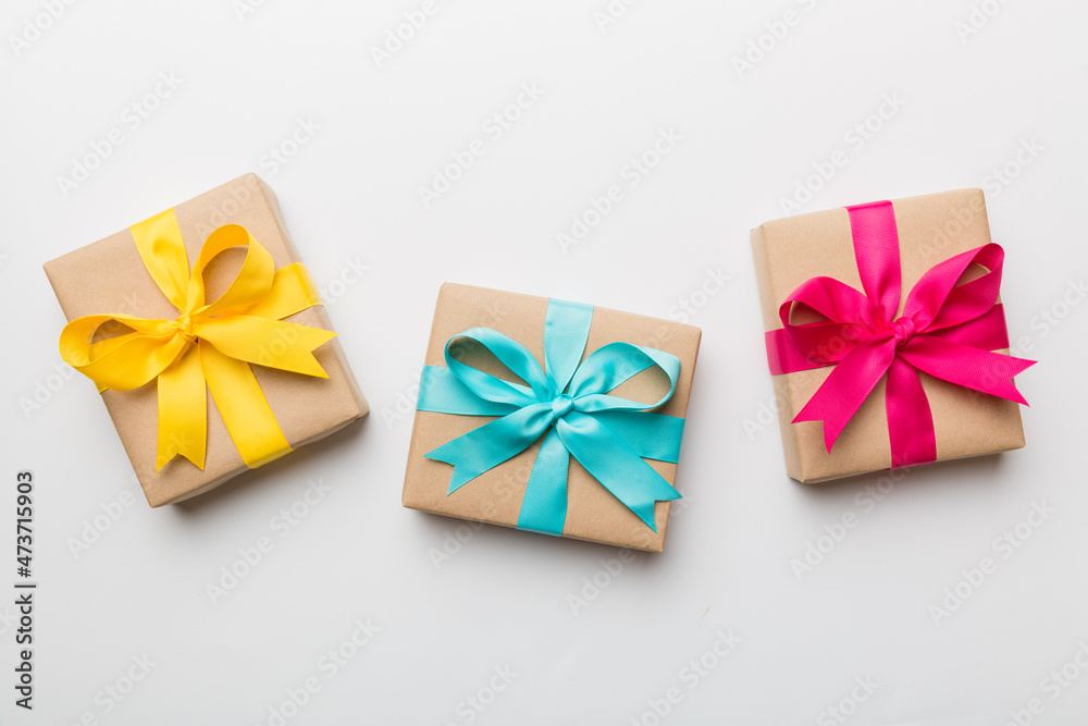 Holiday present box over colored background, top view Holiday present box over colored background, top view
