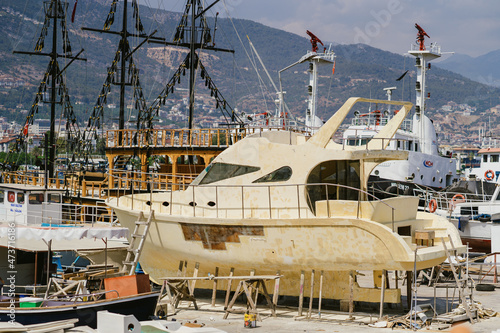 Alanya, Turkey - 24 July 2021: Sea pier port for yachts and boats in marina on a background of mountainous terrain. Sea coast © diignat
