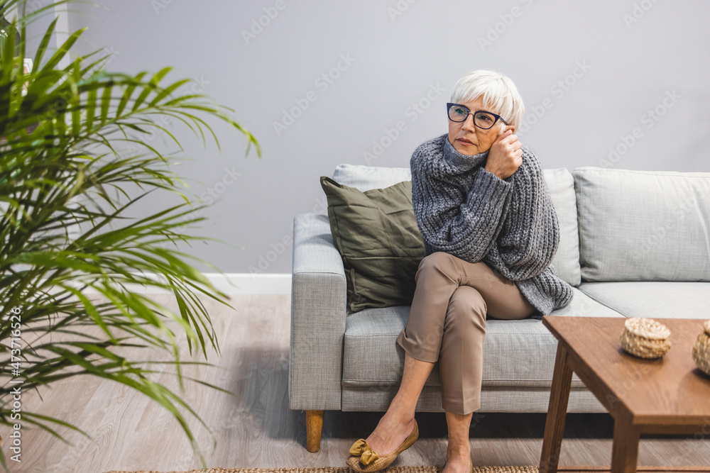 Thoughtful serious anxious mature senior woman feeling blue worried about problems, pensive upset sad middle aged grey haired lady looking away thinking of loneliness, getting older and depression