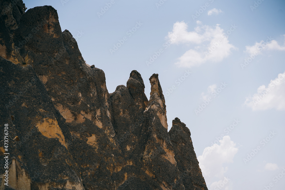 Picturesque summer view Scenic on landscape view of geologic formations of Cappadocia. Amazing shaped sandstone rocks. Famous touristic place and romantic travel destination.. Picturesque summer view Scenic on landscape view of geologic formations of Cappadocia. Amazing shaped sandstone rocks. Famous touristic place and romantic travel destination..