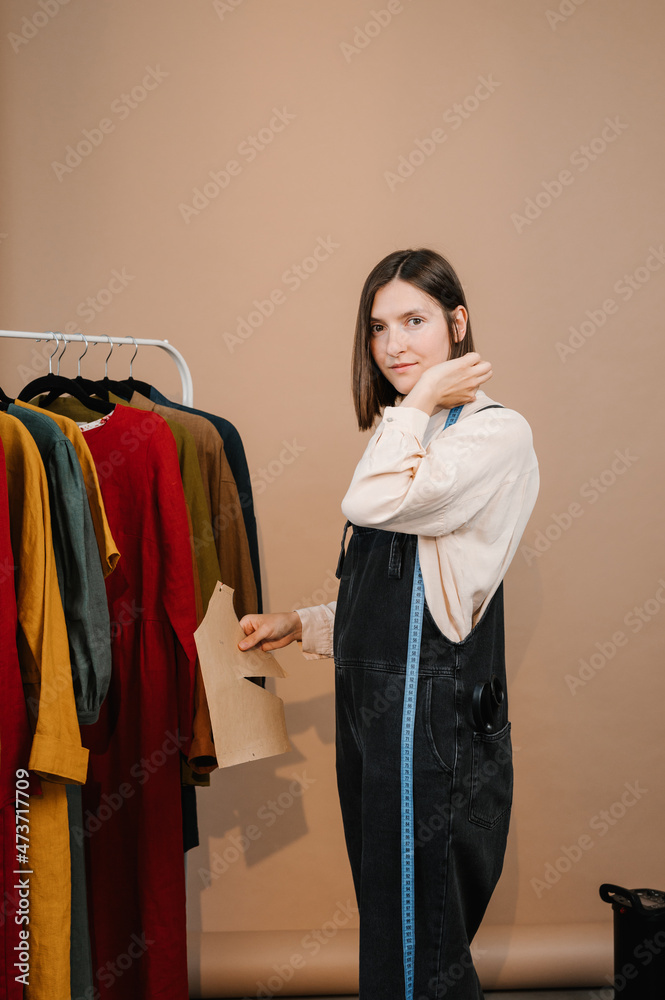 Dressmaker with clothes and measuring tape Dressmaker with clothes and measuring tape