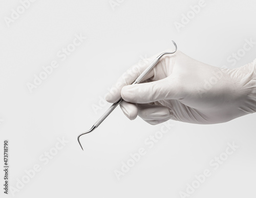 Dental drilling tool in dentist hand on white backgroud