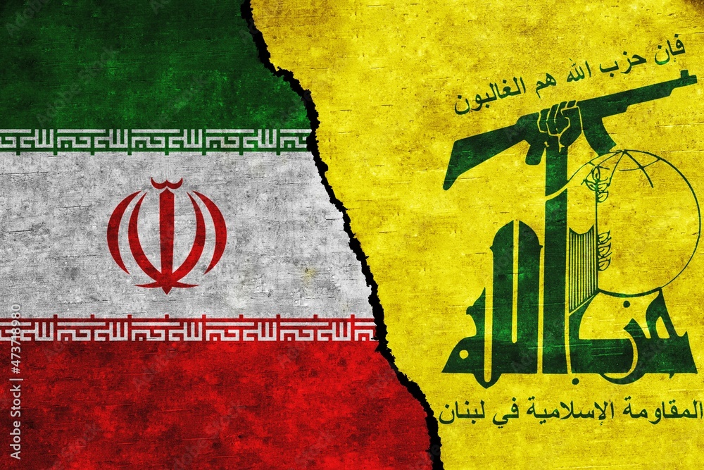 Iran and Hezbollah painted flags on a wall with a crack. Iran and