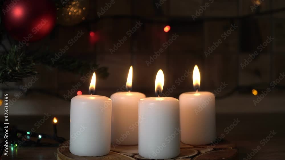Burning candles in the evening by the Christmas tree. Christmas Eve, Christmas or New Years concept Burning candles in the evening by the Christmas tree. Christmas Eve, Christmas or New Years concept