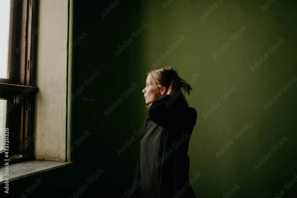 portrait of a blonde woman by the window portrait of a blonde woman by the window