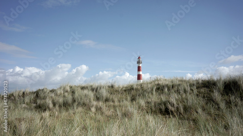 Lighthouse tower behing the dunes photo