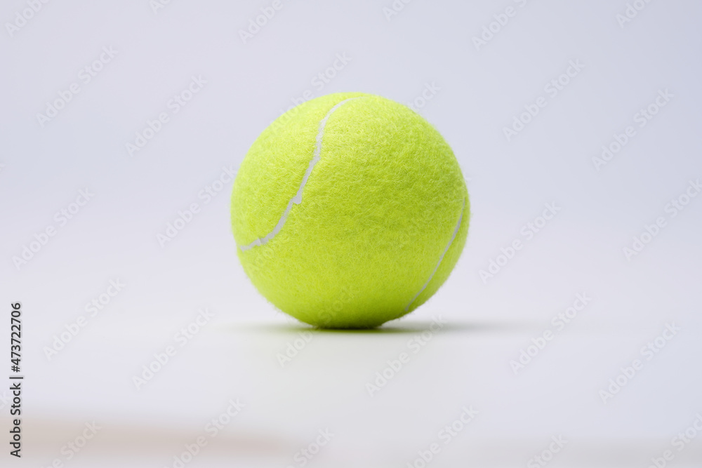 Bright lime tennis ball on white background closeup
