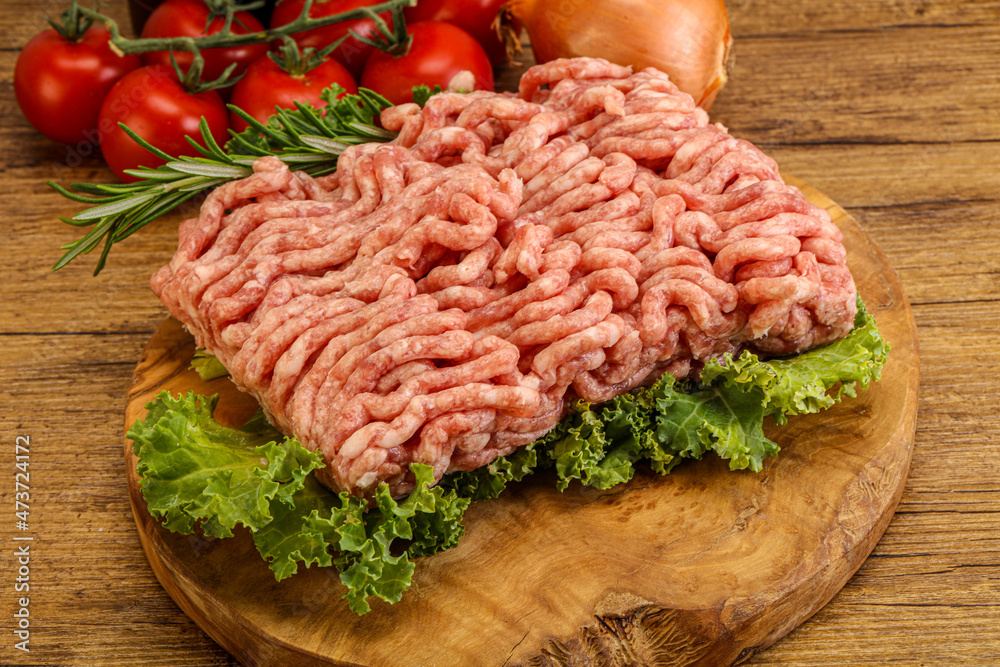 Raw pork minced meat over board Raw pork minced meat over board