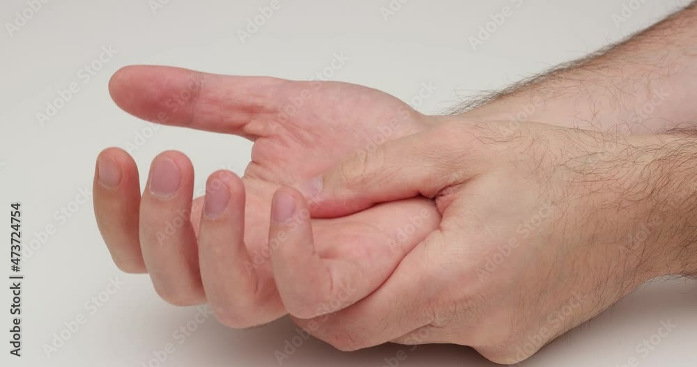 Caucasian male hands massaging wrist and palm with finger. Office work pain relief. Close up, top view, real time, unrecognizable, no face Caucasian male hands massaging wrist and palm with finger. Office work pain relief. Close up, top view, real time, unrecognizable, no face