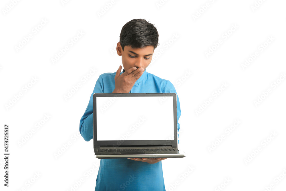Indian child wearing traditional cloth and showing laptop screen Indian child wearing traditional cloth and showing laptop screen