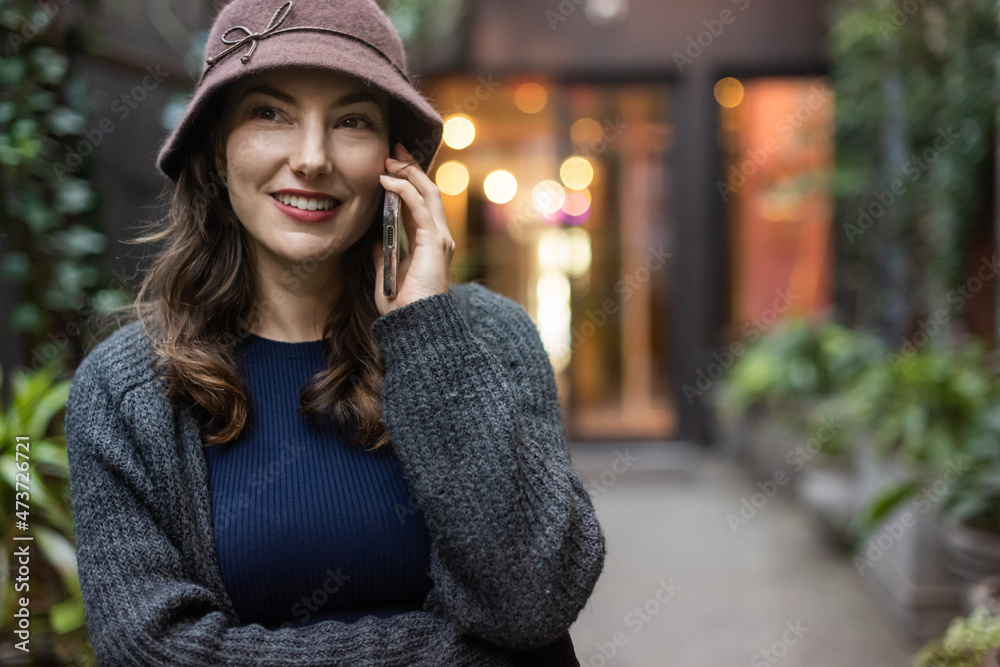 Woman on phone outside of building Woman on phone outside of building