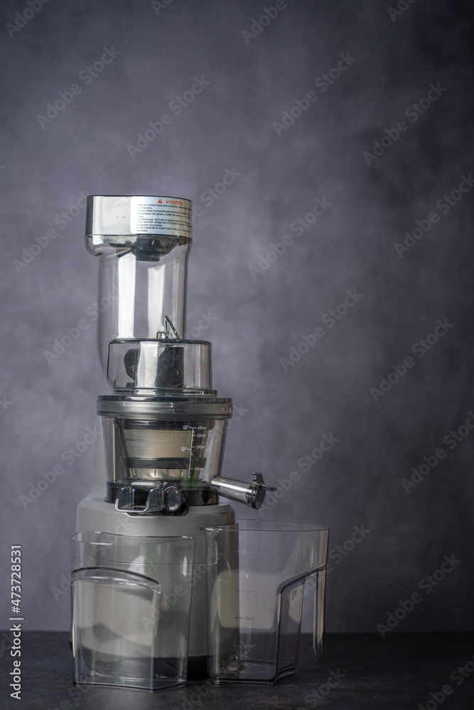 produce juice from oranges and lemons with a juice extractor. everything is photographed on a grey background produce juice from oranges and lemons with a juice extractor. everything is photographed on a grey background