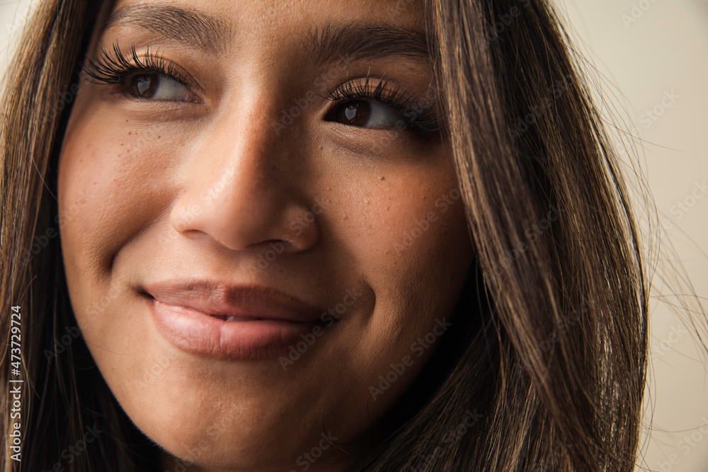 © Anna Tabakova/Stocksy - Closeup of a beautiful asian model smiling