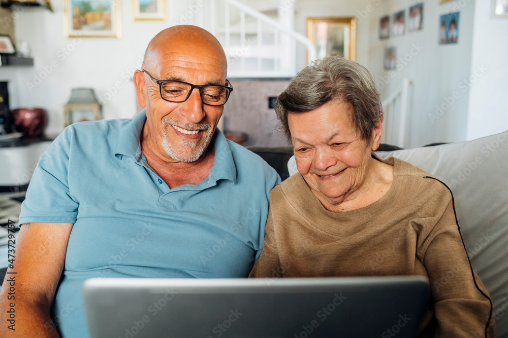 Senior woman using laptop with son at home Senior woman using laptop with son at home
