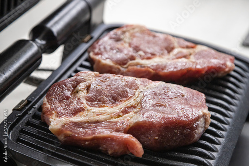 Fresh red meat steak on the grill in the kitchen
