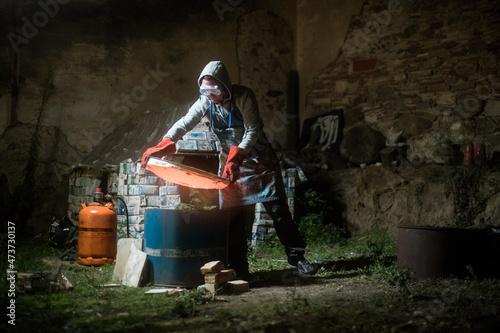 Ceramic sculptor uncovering the oven
