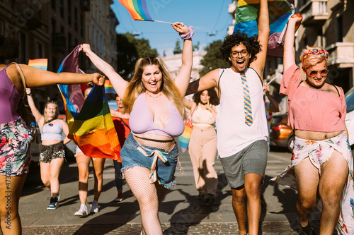 Cheerful male and female protesters in pride event photo