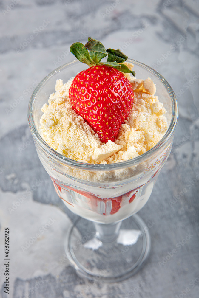 Magnolia dessert with fresh strawberries in glass cup, homemade milky dessert concept Magnolia dessert with fresh strawberries in glass cup, homemade milky dessert concept