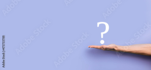 Businessman man hand hold interface question marks sign web. Ask quiestion online, FAQ concept, what where when how and why, search information on internet