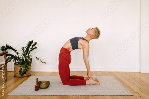 Fit Woman Doing Camel Pose photo