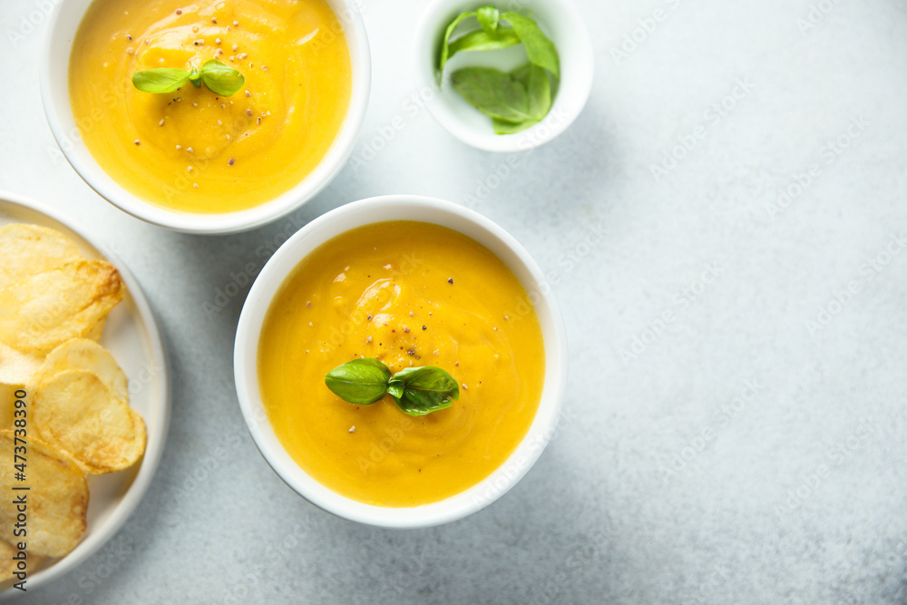 Traditional homemade pumpkin soup with fresh basil Traditional homemade pumpkin soup with fresh basil