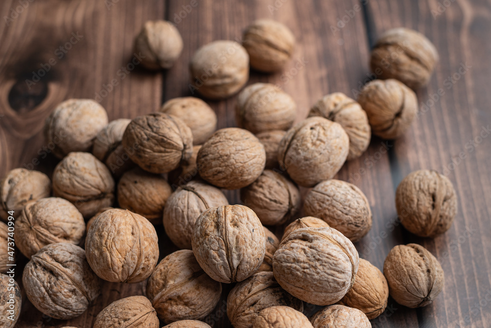 Whole walnuts on a wooden table Whole walnuts on a wooden table
