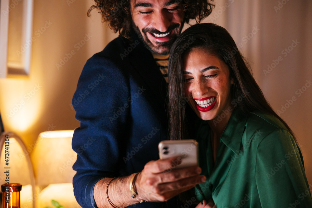 Happy multiracial friends using smartphone together Happy multiracial friends using smartphone together