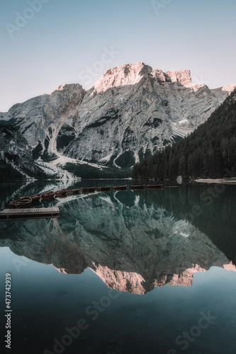 landscape of a lake with boats surrounded by mountains