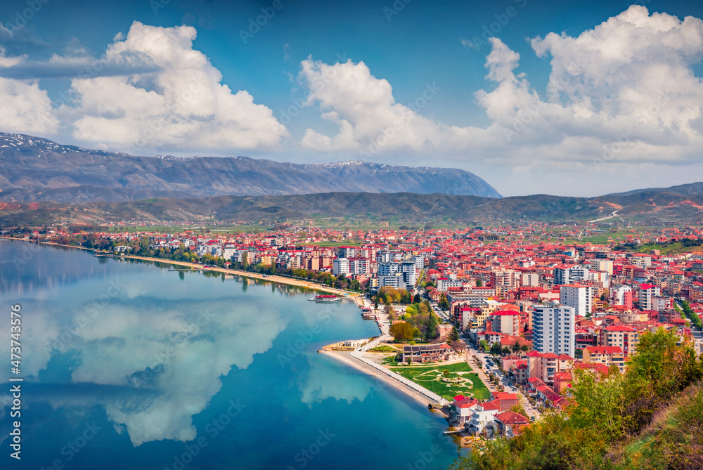 Impressive spring cityscape of Pogradec town. Beautiful outdoor scene of Ohrid lake. Superb morning view of Albania, Europe. Traveling concept background.