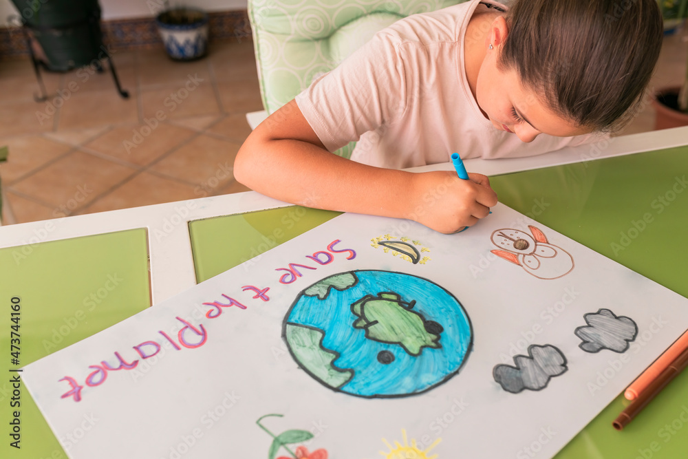 Girl making poster of environmental issues at home Girl making poster of environmental issues at home