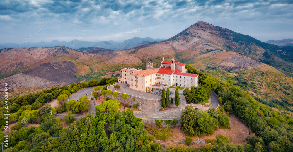 Dramatic summer view from flying drone of Sanctuary of the Madonna della Civita Catholic church. Aerial morning scene of Italy, Europe. Traveling concept background.