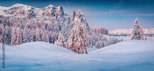 Panoramic morning view of Alpe di Siusi village. Colorful winter sunrise in Dolomite Alps. Unbelievable landscape of Italian ski resort. Beauty of nature concept background.