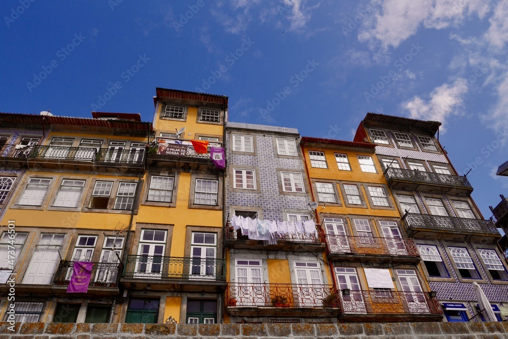 Panoramic view of typical colorful houses with ceramic tiles (azulejos) at waterfront in Ribeira. Porto, Portugal.