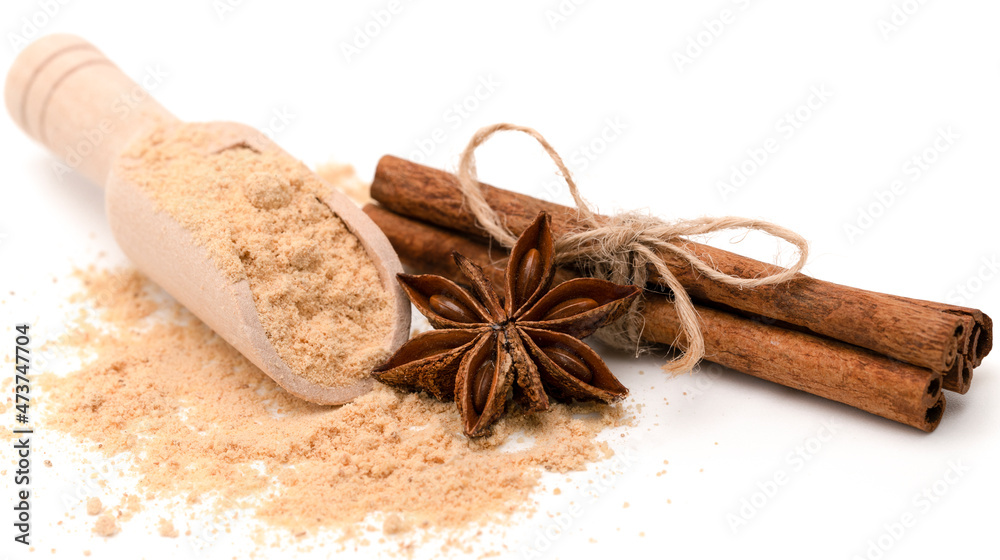 Cinnamon sticks on ground cinnamon. Mixed spices on white Background Cinnamon sticks on ground cinnamon. Mixed spices on white Background