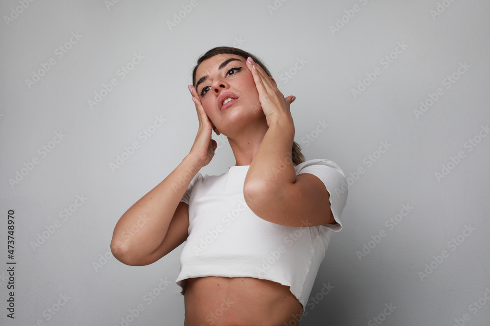 Sad and upset young woman deep in thought, headache and mental issues. Isolated.